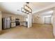 Modern kitchen open to living room with stainless steel appliances and granite counters at 11829 W Rosewood Dr, El Mirage, AZ 85335