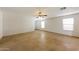 Large living room with tile flooring, a ceiling fan, and ample natural light at 11829 W Rosewood Dr, El Mirage, AZ 85335