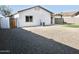A fully enclosed, low-maintenance backyard with desert landscaping and a synthetic grass area at 1187 E Cowboy Cove Trl, San Tan Valley, AZ 85143