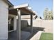 Backyard patio featuring a covered area, desert landscaping, and low-maintenance design at 1187 E Cowboy Cove Trl, San Tan Valley, AZ 85143