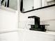 Close-up of a waterfall faucet over a modern sink at 1187 E Cowboy Cove Trl, San Tan Valley, AZ 85143