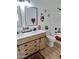 Stylish bathroom with double vanity, wood-look cabinets, and modern fixtures at 1187 E Cowboy Cove Trl, San Tan Valley, AZ 85143