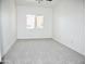 Carpeted bedroom with window showing outside views and neutral decor at 1187 E Cowboy Cove Trl, San Tan Valley, AZ 85143
