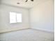 A bright, spacious bedroom with plush carpeting and a large window at 1187 E Cowboy Cove Trl, San Tan Valley, AZ 85143