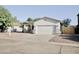 Well-maintained single-story home featuring a desert landscape, palm trees, and a two-car garage at 1187 E Cowboy Cove Trl, San Tan Valley, AZ 85143