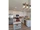 A well-lit kitchen featuring white cabinets, stainless steel appliances, and a stylish island at 1187 E Cowboy Cove Trl, San Tan Valley, AZ 85143