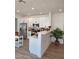 Bright kitchen with stainless appliances, white cabinetry and breakfast bar seating at 1187 E Cowboy Cove Trl, San Tan Valley, AZ 85143