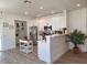 Bright kitchen with stainless appliances, white cabinetry and breakfast bar seating at 1187 E Cowboy Cove Trl, San Tan Valley, AZ 85143