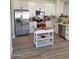 Bright kitchen features stainless appliances and stylish white cabinets at 1187 E Cowboy Cove Trl, San Tan Valley, AZ 85143