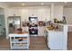 Updated kitchen features stainless steel appliances, white cabinets, and breakfast bar at 1187 E Cowboy Cove Trl, San Tan Valley, AZ 85143