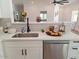 Updated kitchen boasts stainless steel appliances, white cabinets, and breakfast bar at 1187 E Cowboy Cove Trl, San Tan Valley, AZ 85143