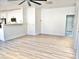 Open-concept living room featuring wood flooring and white walls, seamlessly connected to the kitchen area at 1187 E Cowboy Cove Trl, San Tan Valley, AZ 85143