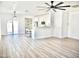 Bright living room with white walls, wood floors, and open concept to the kitchen at 1187 E Cowboy Cove Trl, San Tan Valley, AZ 85143