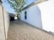 A side yard with desert landscaping and a view of the home's exterior wall at 1187 E Cowboy Cove Trl, San Tan Valley, AZ 85143