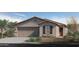 Charming single-story home with a two-car garage and a desert-landscaped front yard at 2731 W La Mirada Dr, Laveen, AZ 85339