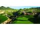 Scenic golf course view showcasing lush green fairways, desert landscaping, and distant mountain views at 30660 N 120Th Ln, Peoria, AZ 85383