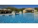 Large pool with clear blue water, tanning gazebos, and decorative tile and statue features at 30660 N 120Th Ln, Peoria, AZ 85383