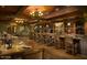 Elegant restaurant featuring a long bar, high stools, ample seating, and sophisticated lighting at 30660 N 120Th Ln, Peoria, AZ 85383