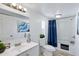 Well-lit bathroom featuring a vanity, mirror, toilet, and a shower with a stylish blue curtain, creating a functional design at 320 E Mckellips Rd # 34, Mesa, AZ 85201