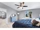 Serene bedroom includes a blue comforter, stylish furnishings, and a window offering a view of palm trees outside at 320 E Mckellips Rd # 34, Mesa, AZ 85201