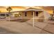 Manufactured home with an oversized covered parking, palm trees, and desert landscaping at sunset at 320 E Mckellips Rd # 34, Mesa, AZ 85201