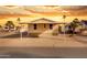 Manufactured home with an oversized covered parking, palm trees, and a beautiful sunset in the background at 320 E Mckellips Rd # 34, Mesa, AZ 85201