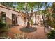 Picturesque courtyard featuring mature trees, native vegetation and beautiful flowering plants at 4518 E Solano Dr, Phoenix, AZ 85018