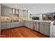 Beautiful kitchen with stainless steel appliances, wood floors, gray cabinets and quartz countertops at 4518 E Solano Dr, Phoenix, AZ 85018