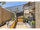 Landscaped backyard with a shade structure, custom garden box, and an arched metal frame at 7756 N 19Th Ln, Phoenix, AZ 85021