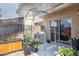 Backyard patio with a metal arched frame, grill, and various potted plants at 7756 N 19Th Ln, Phoenix, AZ 85021
