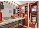 Vibrant bathroom featuring dual sinks, dark cabinets, and a shower, all accented with a striking red color scheme at 7756 N 19Th Ln, Phoenix, AZ 85021