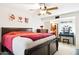 Spacious bedroom with a large bed, ceiling fan, and adjacent vanity area for added convenience at 7756 N 19Th Ln, Phoenix, AZ 85021