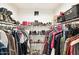 Well-organized walk-in closet with ample storage space, clothing racks, and shelving for shoes and accessories at 7756 N 19Th Ln, Phoenix, AZ 85021