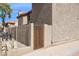 Stucco property with a wooden side gate and a wrought iron fence along the sidewalk at 7756 N 19Th Ln, Phoenix, AZ 85021