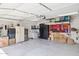 Spacious garage with storage cabinets, shelving, and ample room for vehicles at 7756 N 19Th Ln, Phoenix, AZ 85021
