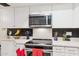 Well-lit kitchen featuring stainless steel appliances and sleek countertops at 7756 N 19Th Ln, Phoenix, AZ 85021
