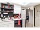 Cozy kitchen with stainless steel refrigerator, open shelving, and modern finishes at 7756 N 19Th Ln, Phoenix, AZ 85021