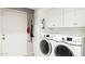 Functional laundry room equipped with modern washer and dryer units and ample storage at 7756 N 19Th Ln, Phoenix, AZ 85021