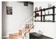 Inviting staircase featuring decorative shelves and stylish artwork at 7756 N 19Th Ln, Phoenix, AZ 85021