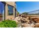 Serene backyard with rock garden, mature bushes and exterior entrance at 7955 E Chaparral Rd # 17, Scottsdale, AZ 85250