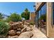 Spacious backyard with rock garden and mature trees behind fence at 7955 E Chaparral Rd # 17, Scottsdale, AZ 85250