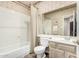 Traditional bathroom featuring a tub-shower combo, floral wallpaper, and a vanity at 7955 E Chaparral Rd # 17, Scottsdale, AZ 85250