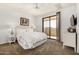 Cozy bedroom with plush carpet, ceiling fan and sliding glass door to private patio at 7955 E Chaparral Rd # 17, Scottsdale, AZ 85250