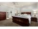 Primary bedroom with ensuite bathroom, a large bed, and wood dresser at 7955 E Chaparral Rd # 17, Scottsdale, AZ 85250