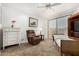 Comfortable bedroom with a recliner, white dresser, and sliding glass door at 7955 E Chaparral Rd # 17, Scottsdale, AZ 85250