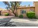 Street view of charming two-story home with desert landscaping and a tile roof at 7955 E Chaparral Rd # 17, Scottsdale, AZ 85250