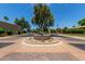 Community circular fountain, with paved roads, mature landscaping, and desert landscaping around the roundabout at 7955 E Chaparral Rd # 17, Scottsdale, AZ 85250