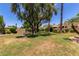 Inviting green space with mature trees and desert landscaping and a bench to enjoy the views at 7955 E Chaparral Rd # 17, Scottsdale, AZ 85250