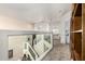 Open hallway featuring glass railing and a staircase with views of the living spaces at 7955 E Chaparral Rd # 17, Scottsdale, AZ 85250