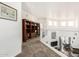 Spacious hallway with a built-in bookshelf and views of the dining room and staircase at 7955 E Chaparral Rd # 17, Scottsdale, AZ 85250
